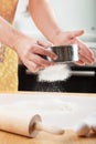 Mans hands sifting flour through a sieve for baking Royalty Free Stock Photo