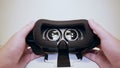 Mans hands take virtual reality glasses, vr and wear them, white background