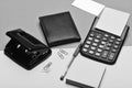 Mans leather wallet and stationery. Calculator, hole punch, business card, note paper, pen and clips. Business and work Royalty Free Stock Photo