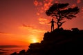 Mans silhouette against a tree lined cliff at the golden sunset