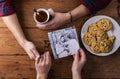 Mans and womans hands. Black-and-white photo. Couple. Tea and cookies.