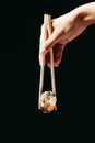 Mansa Maki roll in the Chinese chopsticks Royalty Free Stock Photo