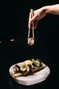 Mansa Maki roll in the Chinese chopsticks in hand Royalty Free Stock Photo