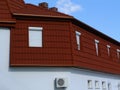 Mansard roof exterior detail with brown clay tile roof covering Royalty Free Stock Photo