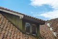 Mansard window in old tiled roof Royalty Free Stock Photo