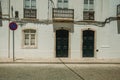 Mansion facade with cracked wall and NO WAITING road sign