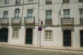 Mansion facade with cracked wall and NO WAITING road sign