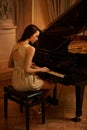 Mansion, play and piano with woman musician, lounge and pianist in a ballroom with luxury instrument. Entertainment Royalty Free Stock Photo