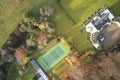 Mansion and private tennis court in real estate grounds aerial view from above in summer London UK