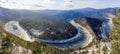 The manskaya loop is a winding river in snowy Siberia. beautiful view from the mountain to the coniferous forest and