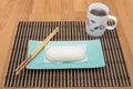 Mantou Chinese steamed bun in green dish on bamboo mat