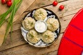 Manty with beef and sour cream top view on wooden table, uzbek cuisine Royalty Free Stock Photo