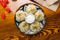 Manty with beef with sour cream on wooden table top view Royalty Free Stock Photo