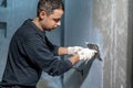manual application of waterproofing to the wall on the construction site
