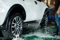 Manual Car Wash. Man using High Pressure Water Machine and Soap to Cleaning Car Royalty Free Stock Photo