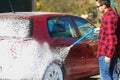 Manual car wash with pressurized water in car wash outside.Summe Washing. Cleaning Car Using High Pressure Water. Royalty Free Stock Photo