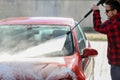 Manual car wash with pressurized water in car wash outside.Summe Washing. Cleaning Car Using High Pressure Water. Royalty Free Stock Photo