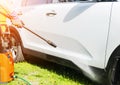 Manual car wash with pressurized water in car wash outside. Summer Car Washing. Cleaning car using high pressure water. Car detail Royalty Free Stock Photo