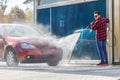 Manual car wash with pressurized water in car wash outside.Summe Washing. Cleaning Car Using High Pressure Water. Royalty Free Stock Photo