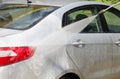 Manual car washing cleaning with foam and pressured water at service station