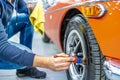 manual cleaning of car tires with a brush Royalty Free Stock Photo