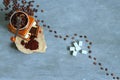 Manual coffee grinder, beans, ground coffee and sugar on a gray concrete background, top view