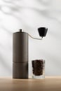 Manual coffee grinder and dark roast coffee beans