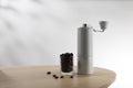 Manual coffee grinder and dark roast coffee beans