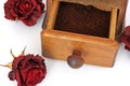 Manual coffee grinder with roses on a white background. Antiquary