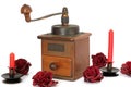 Manual coffee grinder with roses on a white background. Antiquary