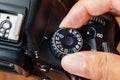 Manual dial mode on dslr camera with fingers on the dial Royalty Free Stock Photo