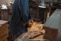 Manual female labor. Woman works in a wood workshop. Close-up