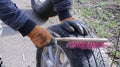 Manual home cleaning of wheel tires with a brush Royalty Free Stock Photo