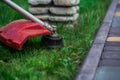 Manual lawn mower on the background of green grass