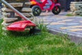 Manual lawn mower on the background of green grass