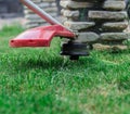 Manual lawn mower on the background of green grass