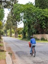 Manual mail deliveries by a postman on a bicycle in South Africa