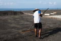 Traditional sea salt production on on the volcanic black sand, B