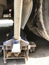 Manual mechanical jack lift jacking up a car to change burst tire in a garage Royalty Free Stock Photo