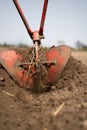 Manual plow on the field close up, agriculture hand tool Royalty Free Stock Photo