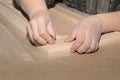 Manual grinding of wooden furniture facade in joinery production