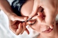 Manual sculpting face massage in spa center. Therapist hands make facial massage on eyebrow for woman in cosmetology clinic