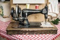 Manual sewing machine used to embroider wooden shapes.