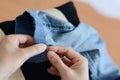 Manual sewing moment by hands: inserting the needle in fabric