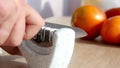 Manual sharpening of a knife in a special sharpener Royalty Free Stock Photo