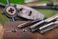 Manual thread cutting in metal. Locksmith accessories for small work in the home workshop Royalty Free Stock Photo