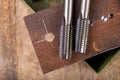 Manual thread cutting in metal. Locksmith accessories for small work in the home workshop