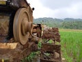 A manual tractor made of steel for plowing rice fields used to prepare land for rice cultivation.