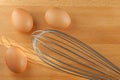 Manual whisk beater with fresh eggs for whipping eggs process. Royalty Free Stock Photo