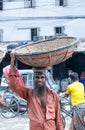 Manual worker carrying a basket on his head